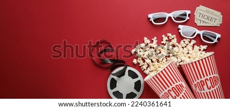 Flat lay composition with delicious popcorn, cinema tickets and glasses on red background, space for text. Banner design