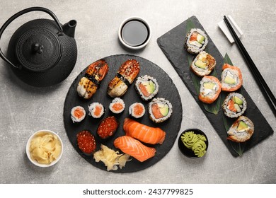 Flat lay composition with delicious sushi rolls on light grey table - Powered by Shutterstock