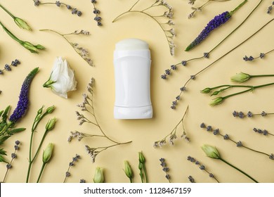 Flat lay composition with deodorant and herbs on color background