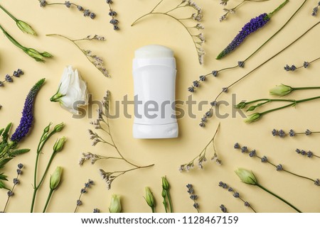 Flat lay composition with deodorant and herbs on color background