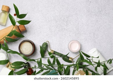 Flat lay composition with different body care products on light textured table. Space for text