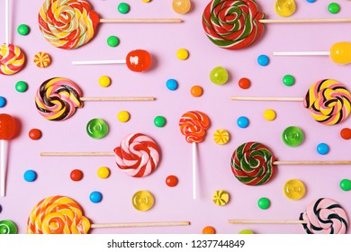 Flat lay composition with different candies on color background