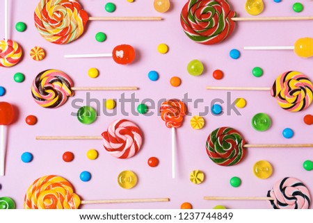 Flat lay composition with different candies on color background