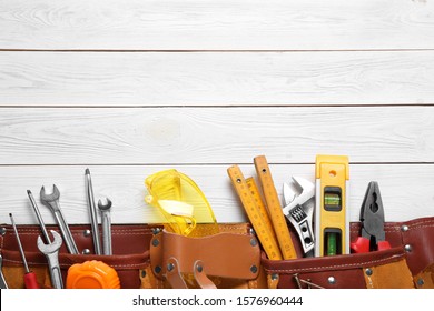 Flat lay composition with different construction tools and space for text on white wooden background