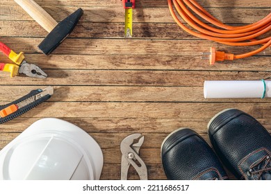 Flat lay composition with different construction tools on wooden background.