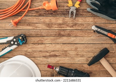 Flat lay composition with different construction tools on wooden background.