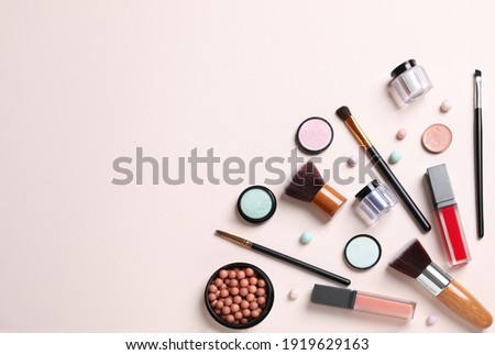 Flat lay composition with different cosmetic products on beige background. Space for text