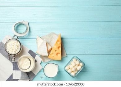 Flat lay composition with different dairy products on wooden background
