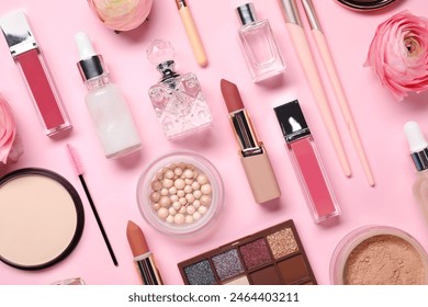 Flat lay composition with different makeup products and beautiful spring flowers on pink background