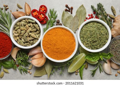 Flat lay composition with different natural spices and herbs on light grey table - Shutterstock ID 2011621031