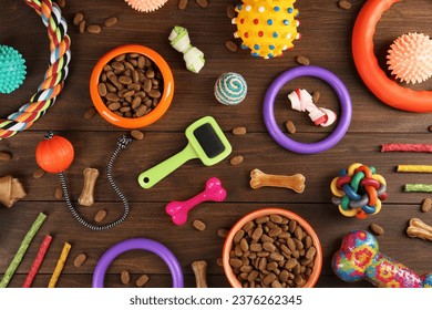 Flat lay composition with different pet goods on wooden background. Shop assortment