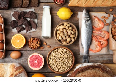 Flat lay composition of different products on wooden table. Food allergy concept
