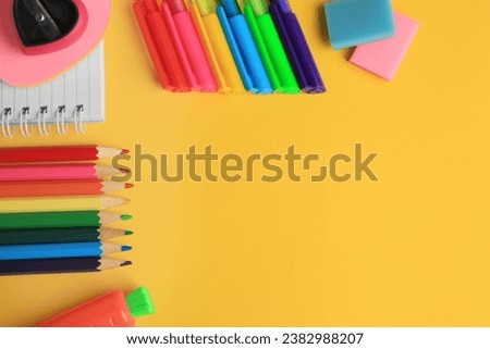 Flat lay composition with different school stationery on yellow background, space for text. Back to school