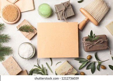 Flat lay composition with different soap bars and blank card on light background. Space for text
