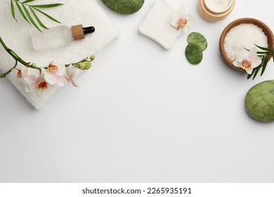 Flat lay composition with different spa products on white background. Space for text