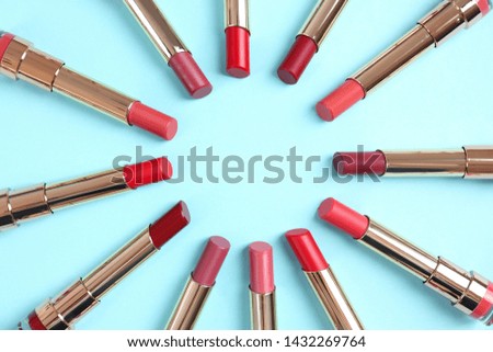 Flat lay composition with different stylish lipsticks on color background, space for text