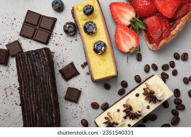 Flat lay composition with different tasty cakes on light grey table