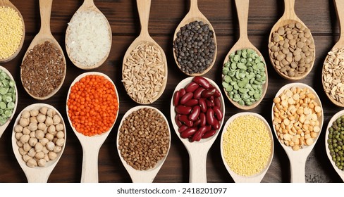 Flat lay composition with different types of legumes and cereals on wooden table. Organic grains