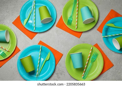 Flat lay composition with disposable tableware on light background