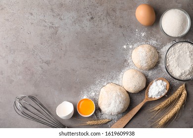Flat lay composition with dough on grey table, space for text. Cooking pastries