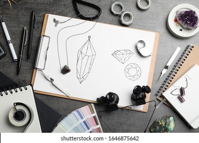 Flat lay composition with drawing of jewelry on grey table. Designer's workplace