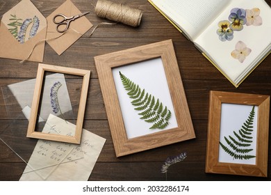 Flat lay composition with dried flowers and plants on wooden table