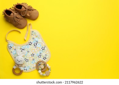 Flat Lay Composition With Drool Baby Bib And Accessories On Yellow Background. Space For Text