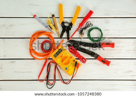 Flat lay composition with electrical tools on wooden background