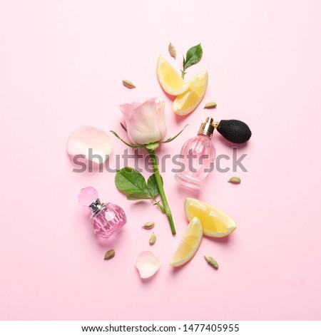 Flat lay composition with elegant perfumes on pink background