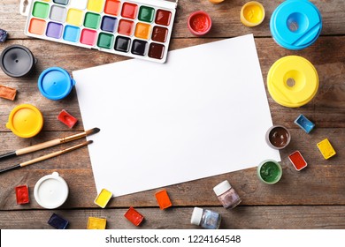 Flat Lay Composition With Empty Paper And Painting Supplies For Child On Table. Space For Text