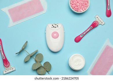 Flat Lay Composition With Epilator And Other Hair Removal Products On Light Blue Background