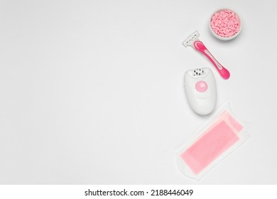 Flat Lay Composition With Epilator And Other Hair Removal Products On White Background. Space For Text