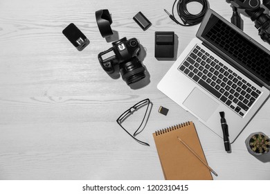Flat lay composition with equipment for professional photographer on wooden background. Space for text - Shutterstock ID 1202310415