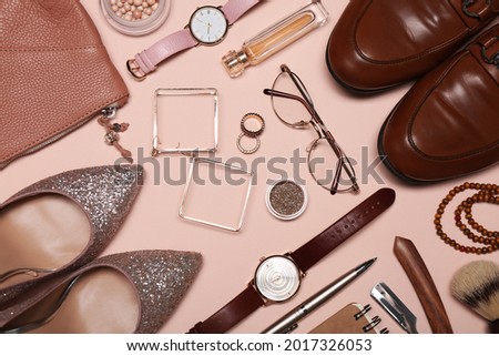 Flat lay composition with fashionable woman's and man's accessories on pink background