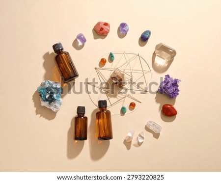 A flat lay composition featuring various crystals, essential oil bottles, and geometric shapes, evoking a sense of spiritual healing and aromatherapy.
