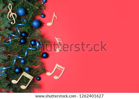 Flat lay composition with fir tree, Christmas decor and wooden music notes on color background. Space for text