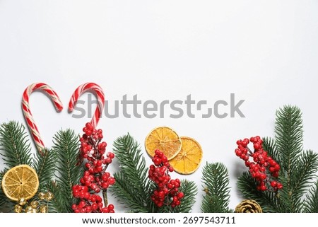 Flat lay composition with fir tree branches and Christmas decor on white background. Space for text