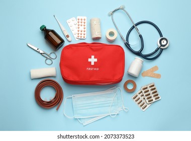 Flat lay composition with first aid kit on light blue background - Powered by Shutterstock