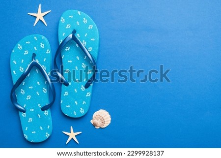 Flat lay composition with flip flops and seashell on colored background. Space for text top view.