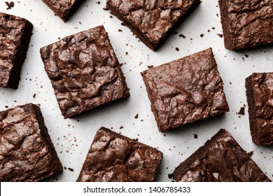 Flat lay composition with fresh brownies on parchment paper. Delicious chocolate pie