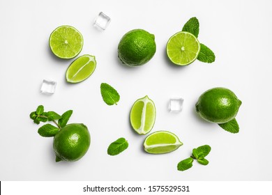 Flat lay composition with fresh juicy limes, mint and ice cubes on white background - Shutterstock ID 1575529531