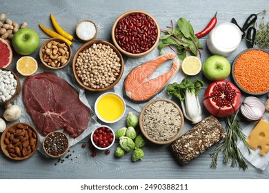 Flat lay composition with fresh meat and other products for balanced diet on grey wooden table