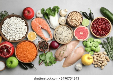 Flat lay composition with fresh meat and other products for balanced diet on light grey table