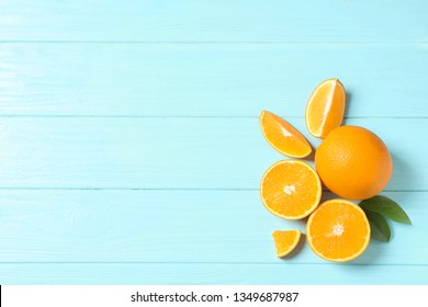 Flat lay composition with fresh oranges on wooden background. Space for text