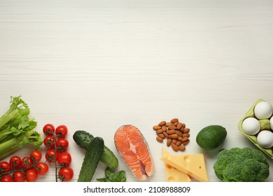 Flat lay composition with fresh organic products on white wooden table, space for text. Keto diet