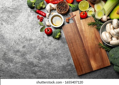 Flat lay composition with fresh products on grey table, space for text. Healthy cooking