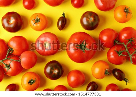 Flat lay composition with fresh ripe tomatoes on yellow background