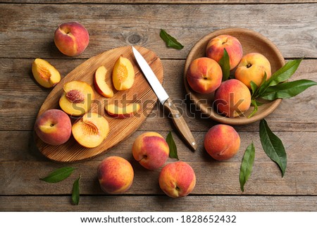 Flat lay composition with fresh sweet peaches on wooden table