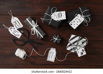 Flat lay composition with gift boxes on wooden table. Creating advent calendar