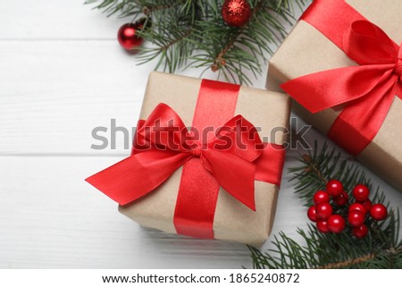 Flat lay composition with gift boxes and Christmas decorations on white wooden table